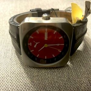 New with tags black leather band, red face puma watch
